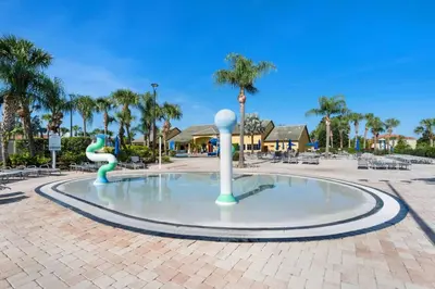 a fountain in the middle of a courtyard with palm trees at 8960 Paradise Palms in Kissimmee