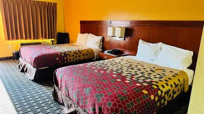 a hotel room with two beds and a window at Budget Inn Of Orlando in Orlando