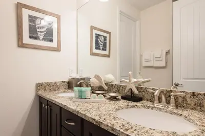 a bathroom with two sinks and a large mirror at Inviting Home With Private Pool Near Disney With Water Park & Resort Access At Encore Resort - 7498Mr in Kissimmee