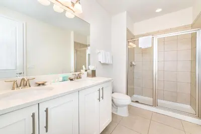 a bathroom with a sink and a toilet and a shower at Exquisite Home With Media Room & Games With Waterpark & Resort Access Near Disney At Encore Resort- 7600Mc in Kissimmee