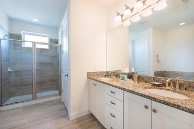a bathroom with two sinks and a shower at Luxury Home Near Disney With Private Pool, Waterpark & Resort Access At Encore Resorts Reunion - 211Mn in Kissimmee