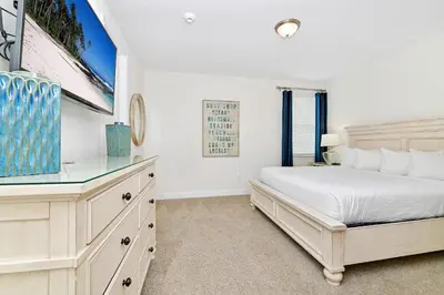 a white bedroom with a bed and a window at Luxury Home With Themed Rooms, Game Room And Waterpark & Resort Access Near Disney At Encore Resorts Reunion - 260Cl in Kissimmee