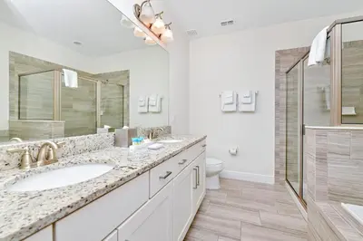 a bathroom with a sink and a shower and a toilet at Luxury Home With Themed Rooms, Game Room And Waterpark & Resort Access Near Disney At Encore Resorts Reunion - 260Cl in Kissimmee