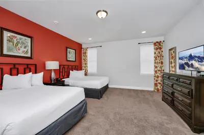 a hotel room with two beds and a television at Vibrant Elite Home With Private Pool, Theater Room And Waterpark & Resort Access Near Disney At Encore Resort - 7605Mc in Kissimmee
