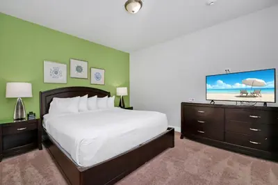 a bedroom with a bed and a flat screen tv at Vibrant Elite Home With Private Pool, Theater Room And Waterpark & Resort Access Near Disney At Encore Resort - 7605Mc in Kissimmee