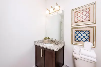 a bathroom with a sink and a toilet at Vibrant Elite Home With Theater Room And Waterpark & Resort Access Near Disney At Encore Resort - 7603Mc in Orlando