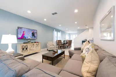a living room with a couch and a tv at Modern Home Near Disney With Private Pool, Media Room And Waterpark & Resort Access At Encore Resorts Reunion - 7576Mr in Kissimmee