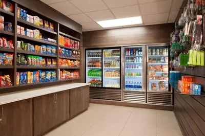 a grocery store aisle with refrigerators and drinks at Residence Inn Orlando Lake Buena Vista in Orlando