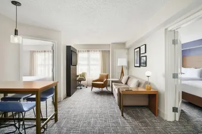 a hotel room with a bed and a living room at Residence Inn Orlando Lake Buena Vista in Orlando