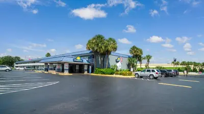 a gas station with cars parked in a parking lot at Days Inn by Wyndham Orlando Downtown in Orlando