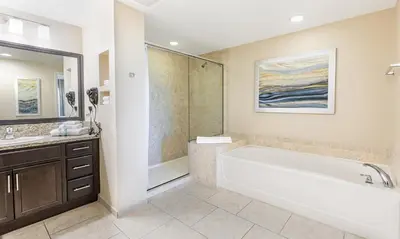 a bathroom with a large tub and a shower at Vacation Village Orlando, Celebration in Orlando