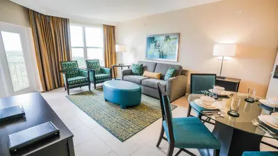 a living room with a couch and a table and chairs at Vacation Village Orlando, Celebration in Orlando