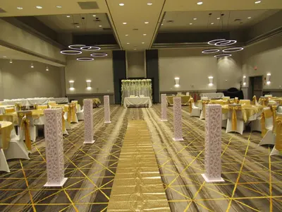 a banquet hall with yellow tables and chairs at Holiday Inn Orlando International Dr-ICON by IHG in Orlando