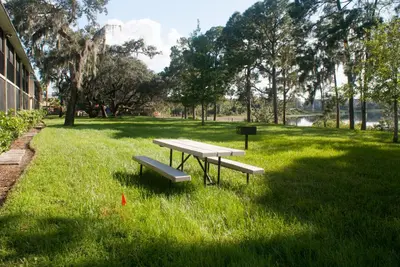 a picnic table and benches in a park at Grand Lake & Lifetime of Vacations Resorts in Orlando