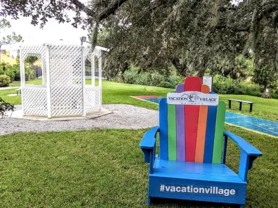 a colorful chair in a yard with a playground at Grand Lake & Lifetime of Vacations Resorts in Orlando