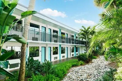 an exterior view of a building with palm trees at Coco Key Hotel & Water Park Resort in Orlando