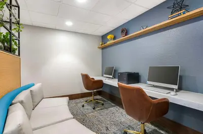 an office with a desk with a computer and two chairs at Best Western Plus Universal Inn - Free Shuttle to Universal Studios! in Orlando