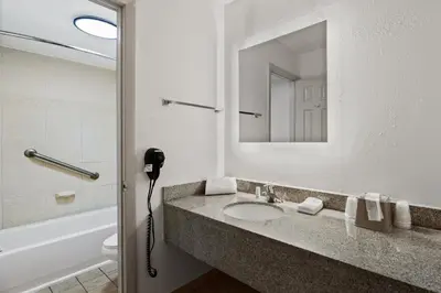a bathroom with a sink and a mirror at Americas Best Value Inn Orlando, FL in Orlando