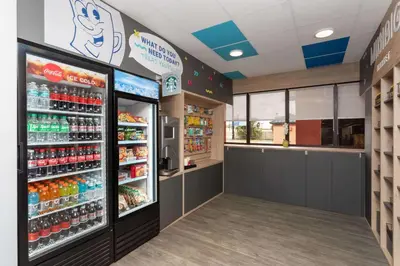 a grocery store with a soda machine in a store at Baymont by Wyndham Orlando North Millenia in Orlando