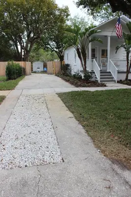 a house with an american flag on the sidewalk at The Shed in Sanford