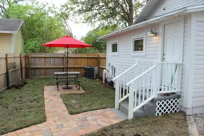 a patio with a table and an umbrella at The Shed in Sanford