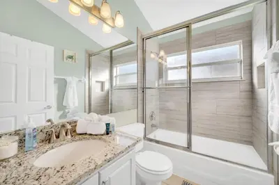 a bathroom with a sink and a toilet and a shower at Indian Creek 3.5 miles from Disney in Orlando