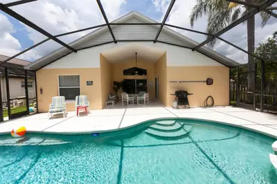 a swimming pool in a house with a building at Indian Creek 3.5 miles from Disney in Orlando