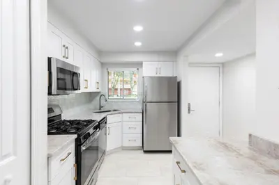 a kitchen with white cabinets and a stainless steel refrigerator at Westgate Leisure Resort in Orlando