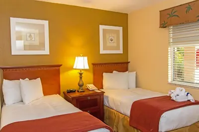 a hotel room with two beds and a phone at Westgate Leisure Resort in Orlando