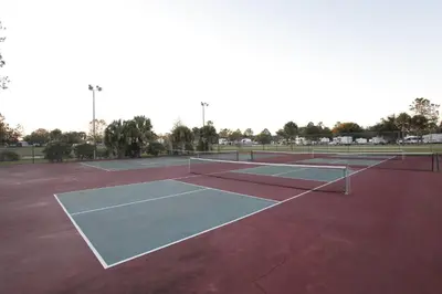 two tennis courts on a tennis court at Orlando RV Resort in Orlando