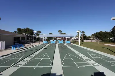 a tennis court with a pavilion in a park at Orlando RV Resort in Orlando