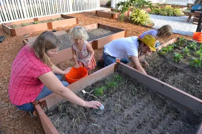 a group of people working in a garden at Orlando RV Resort in Orlando