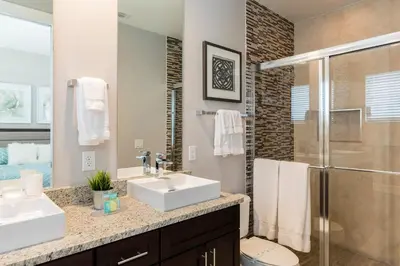 a bathroom with two sinks and a shower at Summerville Vacation Resort in Orlando