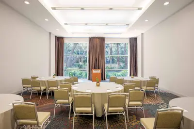 a room with tables and chairs and a large window at The Westin Lake Mary, Orlando North in Lake Mary