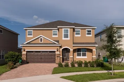 a large house with a driveway at Luxury Disney Dreams Home with Pool, Spa & Game Room in Orlando
