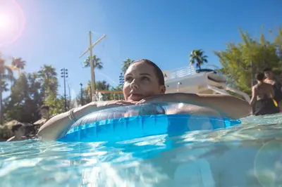 a young man is in a swimming pool at Universal's Loews Royal Pacific Resort in Orlando