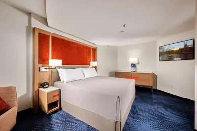 a bedroom with a large white bed and a desk at Universal's Hard Rock Hotel® in Orlando