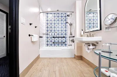 a bathroom with a shower and a sink at Universal's Hard Rock Hotel® in Orlando