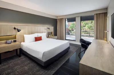 a hotel room with a large bed and a desk at The Delaney Hotel in Orlando