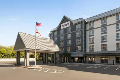 a hotel with an american flag in a parking lot at Spark by Hilton Orlando Universal Boulevard in Orlando