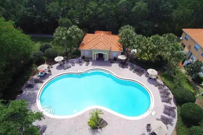 an overhead view of a swimming pool in front of a house at Four Bedrooms Townhome 5126K in Kissimmee