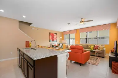 a kitchen and living room with an orange couch at Four Bedrooms Townhome 5126K in Kissimmee