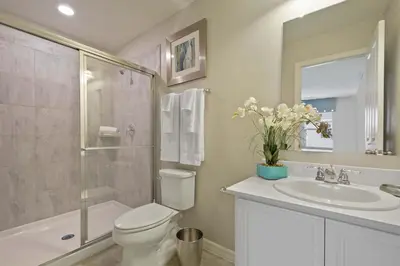 a bathroom with a toilet and a sink and a shower at Four Bedrooms Townhouse 5102 in Kissimmee