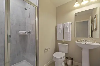 a bathroom with a shower and a toilet and a sink at Four Bedrooms Townhouse 5102 in Kissimmee
