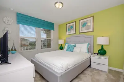 a bedroom with a bed and a television in it at Four Bedrooms Townhouse 5102 in Kissimmee