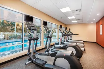 a row of treadmills in a gym with a row of exercise bikes at TownePlace Suites by Marriott Orlando Altamonte Springs/Maitland in Orlando