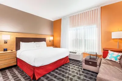 a hotel room with a bed and a couch at TownePlace Suites by Marriott Orlando Altamonte Springs/Maitland in Orlando