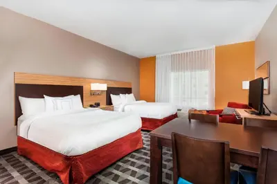 a hotel room with two beds and a desk at TownePlace Suites by Marriott Orlando Altamonte Springs/Maitland in Orlando