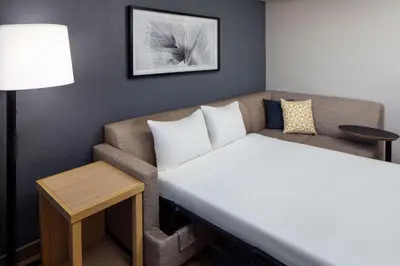 a small room with a couch and a table at Hyatt Place Lake Mary/Orlando North in Lake Mary