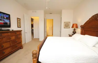a bedroom with a large bed and a television at Shoreway House #231533 in Orlando